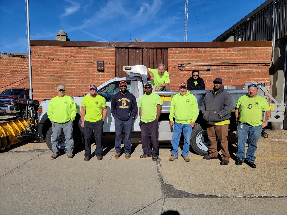 Service Department Team posing in front of new truck.